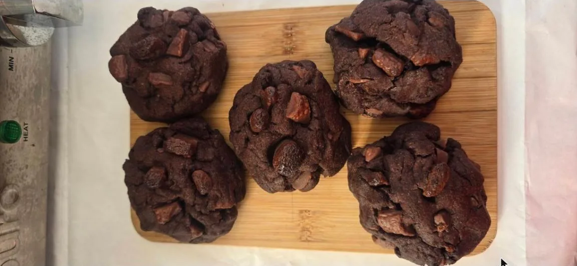 Double chocolate chunk cookies on a timber board