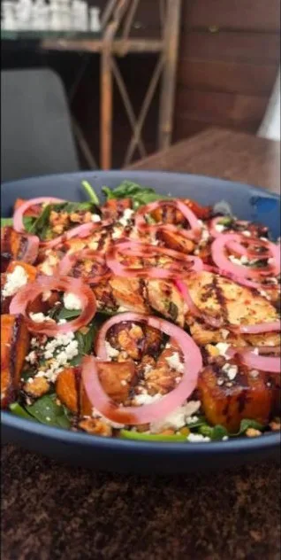 A warm chicken and roast pumpkin salad with pickled onion and fetta