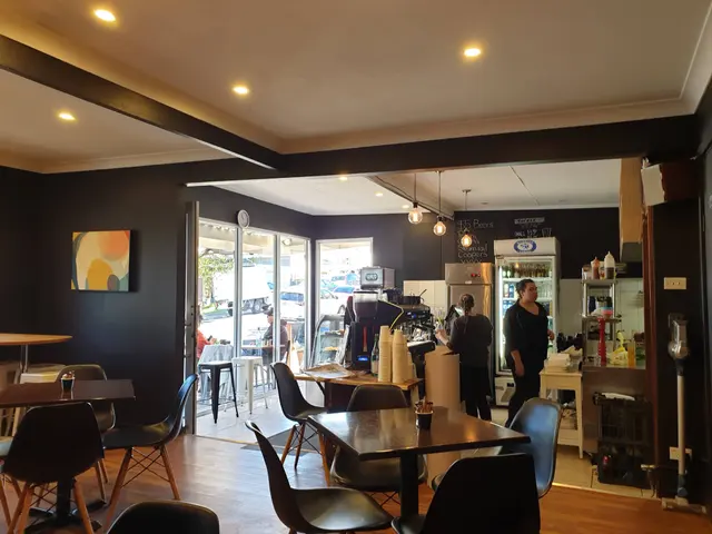 Inside The White Rabbit: timber tables, black chairs and the counter